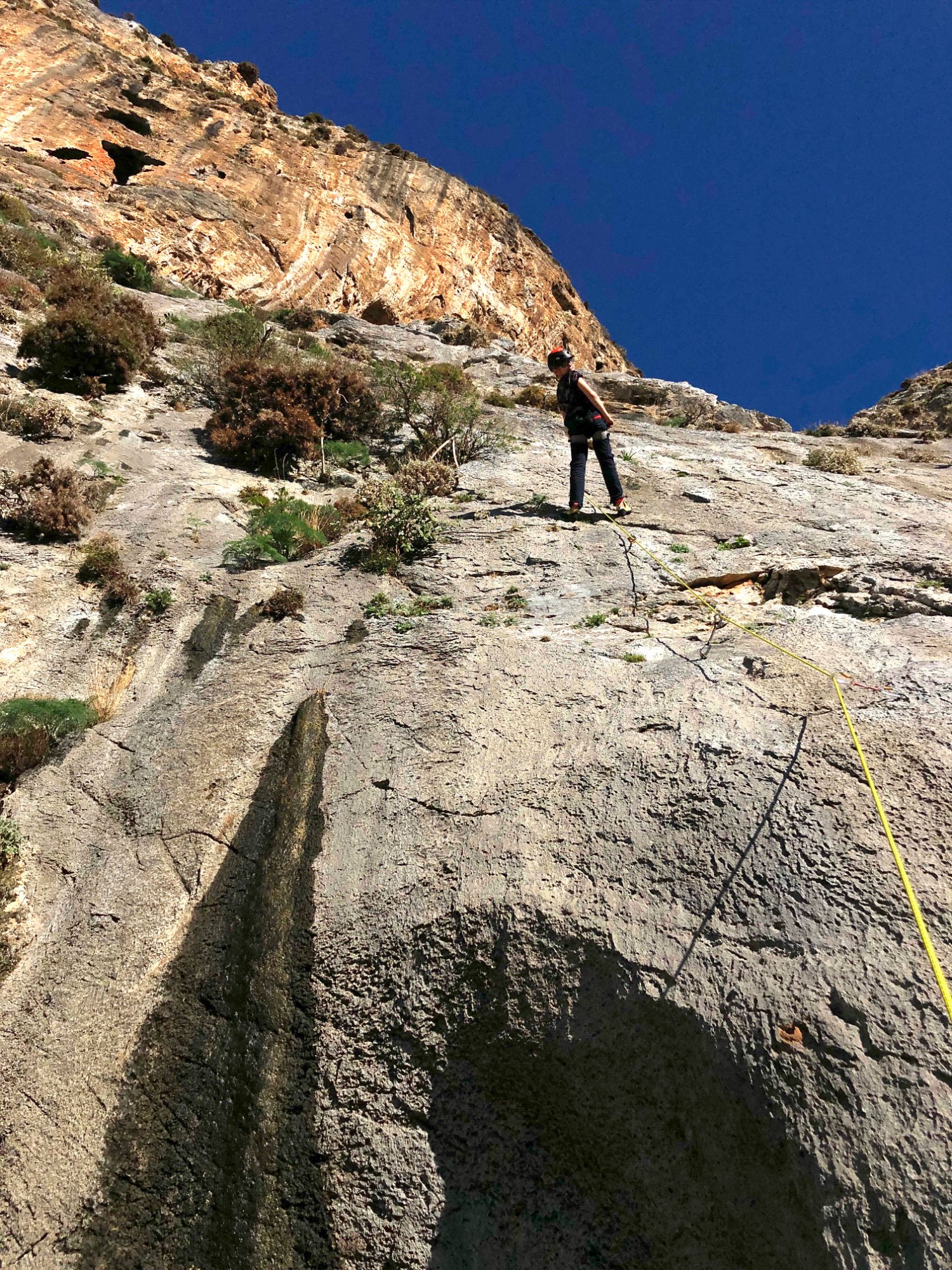A climber high on a slab